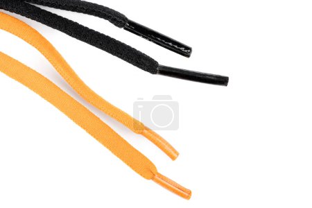 Photo for Black and orange shoelaces on white background - Royalty Free Image