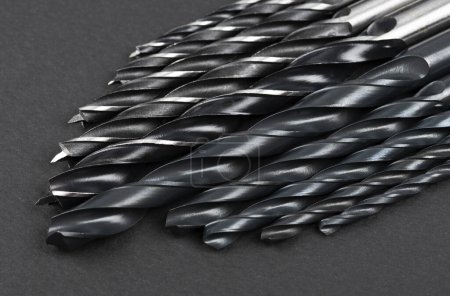 Photo for Set of different drill bits on dark background - Royalty Free Image