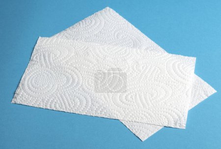 Photo for Pieces of white roll paper towel on blue background - Royalty Free Image
