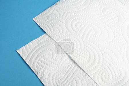 Photo for Pieces of white roll paper towel on blue background - Royalty Free Image