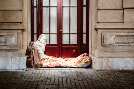 Photo for Illuminated bed of homeless person in front of urban house, Porto, Portugal - Royalty Free Image