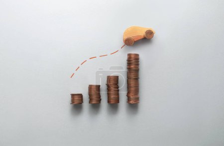 Foto de Increasing fuel, petrol, price concept, business chart stacks of coins with toy wooden car moving upwards - Imagen libre de derechos