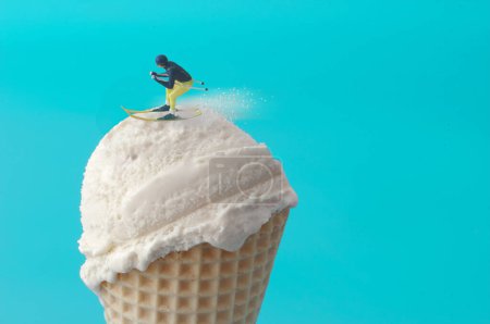 Foto de Esquiador en miniatura deslizándose sobre un cono de helado, concepto de estación de esquí - Imagen libre de derechos