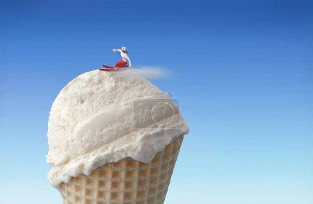 Photo for Miniature skier gliding down an ice cream slope - Royalty Free Image