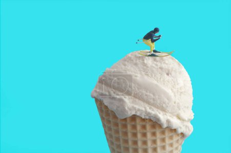 Photo for Miniature skier gliding on top of an ice cream cone, ski resort concept - Royalty Free Image