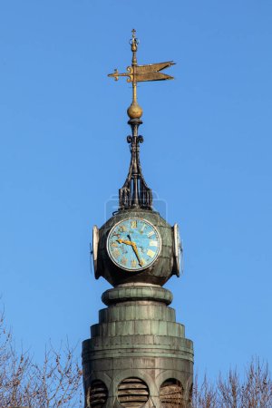 Close-up of the clock and spire of St. Annes Church in the Soho area of London, UK.