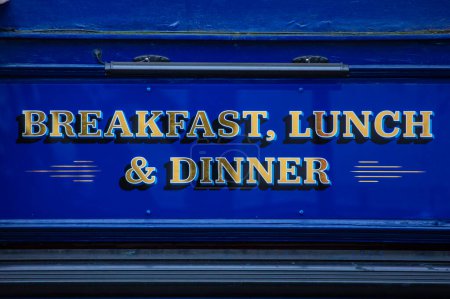 Close-up of a Breakfast, Lunch and Dinner sign.