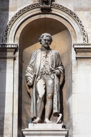 Photo for London, UK - February 26th 2024: A statue of famous artist Joshua Reynolds, on the exterior of Burlington House which is home to the Royal Academy of Art in London, UK. - Royalty Free Image