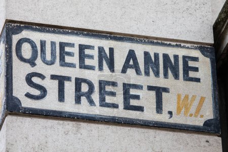 Vintage street sign for Queen Anne Street in the Marylebone area of London, UK.