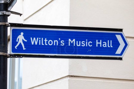 A sign showing the direction to the historic Wiltons Music Hall in East London, UK.