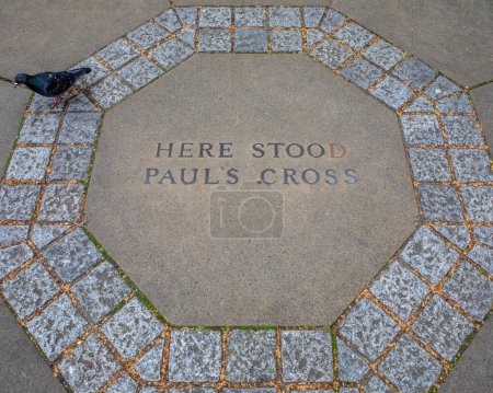 A marker on the ground in St. Pauls Cathedral churchyard in London, UK, marking the location where St. Pauls Cross once stood.