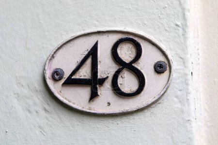 Close-up of a number 48 plaque.