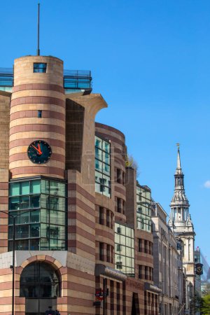 Photo for London, UK - April 17th 2023: No 1 Poultry and the spire of St. Mary-le-Bow church, viewed from Bank in the City of London, UK. - Royalty Free Image