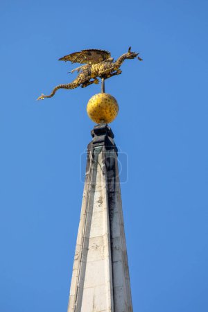 Photo for A beautiful golden Dragon sculpture proudly sitting on the spire of the historic St. Mary-le-Bow church in the City of London, UK. - Royalty Free Image