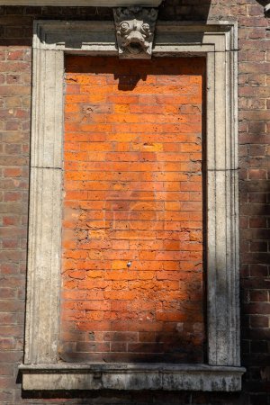 Photo for Close-up of a bricked-up window on the exterior of Trinity Green Almshouses on the Mile End Road in Whitechapel, London, UK. - Royalty Free Image