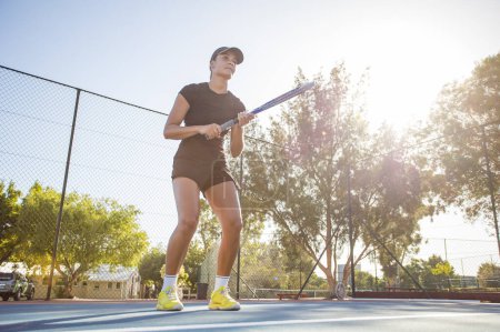 Photo for Young female tennis player in action on a brand new tennis court. - Royalty Free Image