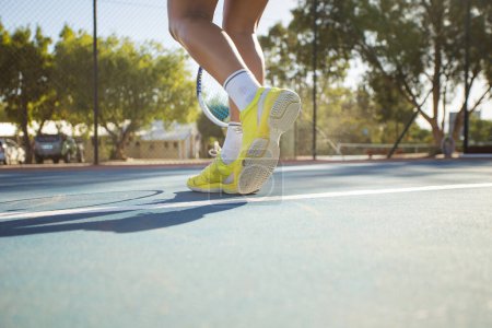 Photo for Young female tennis player in action on a brand new tennis court. - Royalty Free Image
