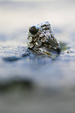 Photo for This stunning close-up image of wedding rings captures the beauty and symbolism of the cherished wedding tradition. The photograph features the bride and groom's wedding rings delicately placed on a neutral surface, highlighting the intricate details - Royalty Free Image