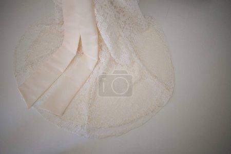 Photo for This captivating image showcases a wedding dress with intricate details photographed in creative and unique ways. The photograph features a stunning white wedding dress with intricate lace detailing and delicate beading. The dress is photographed fro - Royalty Free Image