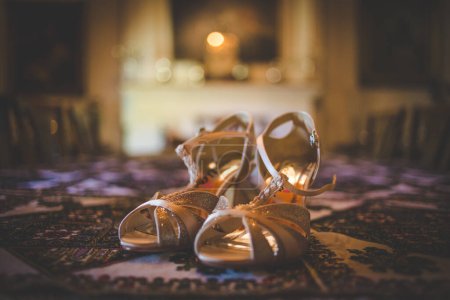 Photo for This captivating image showcases a creative and artistic photograph of bridal accessories, including earrings, shoes, garters, jewelry, and perfume. The photograph is a beautiful composition of various elements, highlighting the intricate details of - Royalty Free Image