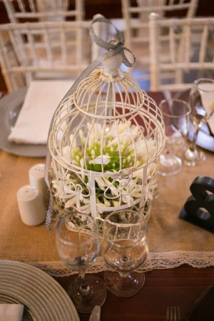 Photo for This captivating image showcases the elegant decor and stunning floral arrangements of a real wedding. The photograph features a beautifully decorated table in a charming wedding venue, adorned with delicate flowers, candles, and other decorative ele - Royalty Free Image