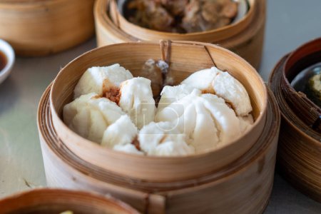 Photo for Steamed buns stuffed with red minced pork holding by hand ready to eating, Asian food - Royalty Free Image