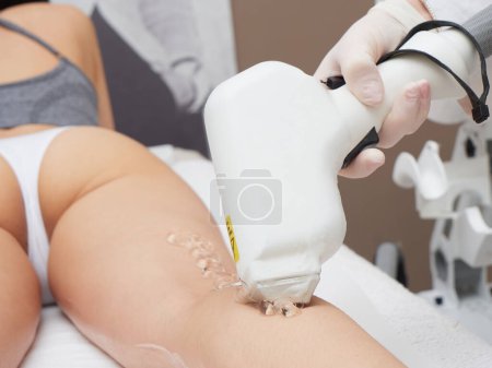 Beautician Removing Hair in spa salon