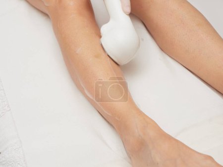 Beautician Removing Hair Of Young Womans body by laser treatment