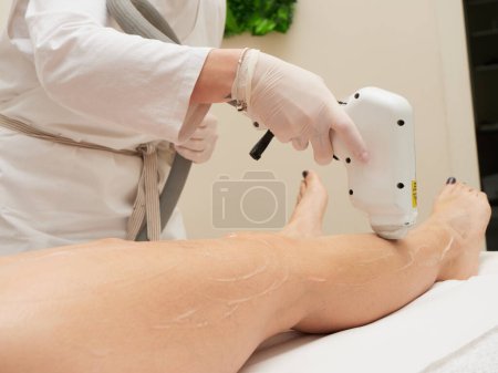 Photo for Beautician Removing Hair Of Young Woman body - Royalty Free Image