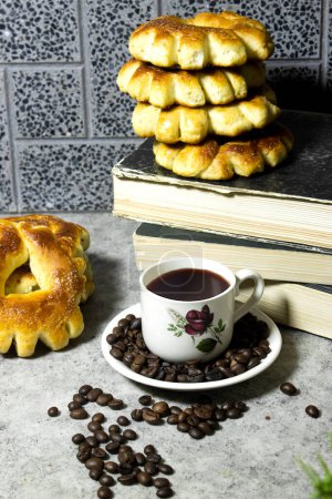 Photo for Homemade algerian cookies ring named " kaak  in arabic " with coffee grinder and cup, beans and books for holidays like eid or ramadan - Royalty Free Image