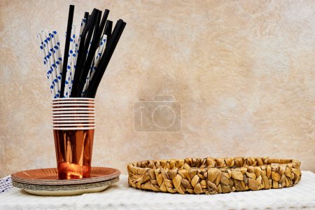 Photo for Birthday or Christmas party concept, empty Esparto halfah plate and paper plate with disposable cup, straws on wood table - Royalty Free Image