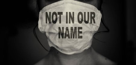 Photo for Woman wearing a mask with not in our name text. Save gaza concept and jewish voice for peace - Royalty Free Image