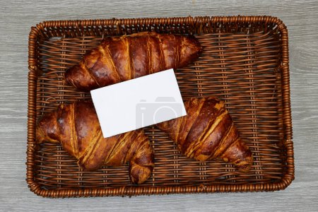 Photo for White card business above Fresh croissants in esparto halfah basket - Royalty Free Image