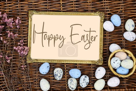 Photo for Golden picture or photo frame mockup with pink baby's breath, gypsophila and eggs on esparto halfah background. happy easter concept - Royalty Free Image