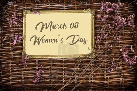 happy women's day on golden picture or photo frame mockup with pink baby's breath, gypsophila on esparto halfah background