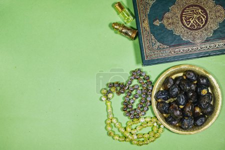 muslim book with arabic calligraphy Traducción del Corán: holy book of Muslims and oud perfume and censer, dates fruit, tasbih. concepto iftar ramadán