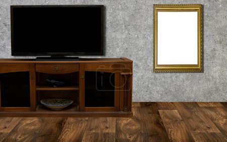 Foto de Una acogedora escena de sala de estar con un moderno televisor de pantalla plana en un gabinete y un marco de imagen en blanco en la pared, listo para maquetas de arte o fotografía - Imagen libre de derechos