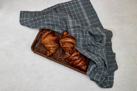 Photo for Esparto halfah basket with Fresh croissants on grunge background - Royalty Free Image