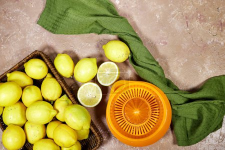 Photo for Halfah basket full of lemons on wood table with plastic squeeze, Gardening concept, lemonade - Royalty Free Image