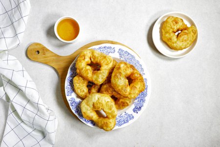traditional Algerian fried baked donuts or pancake named Sfenj with honey bowl