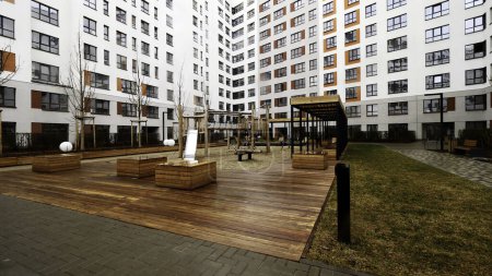 Beautiful courtyard of a new multi storey residential building. Stock footage. Cozy sleeping area with a playground
