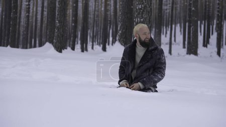 Man in a cold snowy forest. High quality photo