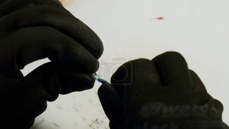 Photo for Soldering iron, wiring repair. Creative. Close up of industrial background of worker in protective gloves repairing a wire - Royalty Free Image