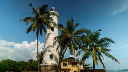 Photo for Galle Lighthouse at Galle Fort, Sri Lanka. Action. Beautiful palm trees and blue cloudy sky - Royalty Free Image