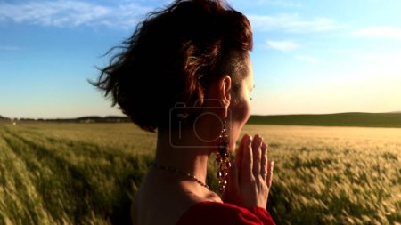 Believing woman with her eyes closed asking for forgiveness and peace. Stock clip. Feeling unity with nature