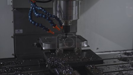 Automated drill on industrial machine. Media. Robotic machine with drill to drill holes in metal. Machine with drill rotates and holes metal plates.