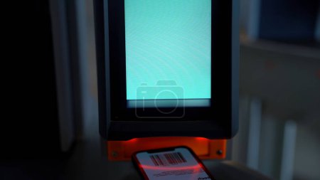 Close up of electronic turnstile with plastic card entering system. Media. Using smartphone with barcode, access control equipment