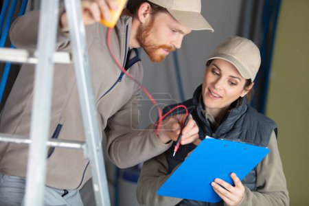 mentor supervising female electrical engineer