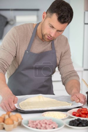 man spiting yeast in dough making process