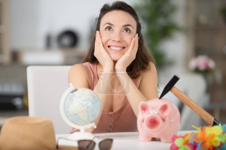 happy woman is holding a piggy bank for travel
